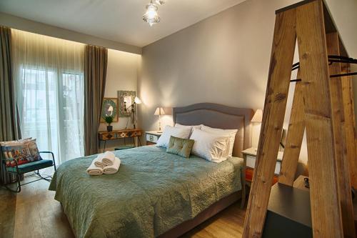a bedroom with a large bed with a wooden ladder at Sali Boutique hotel in Alexandroupoli