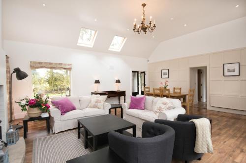 a living room with two couches and a table at The Wild Farm Cottage in Mullingar