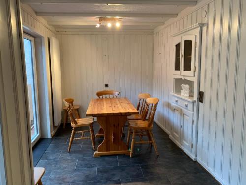 a dining room with a wooden table and chairs at Ferien Haus am Bach in Föhren