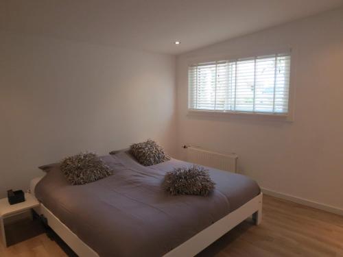 a bedroom with a bed with two pillows on it at 't Salehemse Huuske in Zelhem