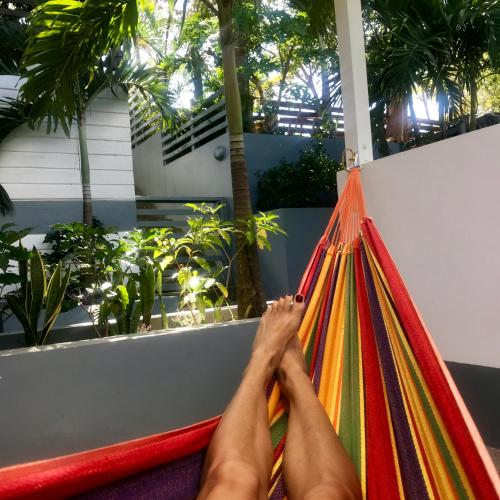 a woman laying on a hammock with her feet up at Oleadas Maderas in San Juan del Sur