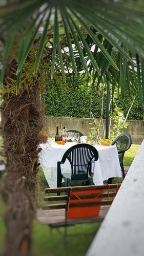 a table with two chairs and a table with a white table cloth at Casa del Vigneto - NEW near VENICE - rooms+bathroom - INDEPENDENT in Spinea