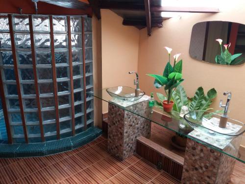 a bathroom with two sinks in a room with mirrors at Khaolak Relax Eco Resort in Khao Lak