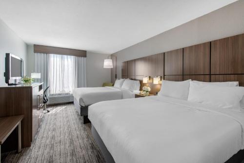a hotel room with two beds and a television at Holiday Inn Melbourne-Viera Conference Ctr by IHG in Melbourne
