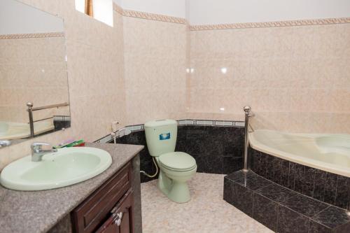 a bathroom with a sink and a toilet and a tub at Rio 6a homestay in Vung Tau