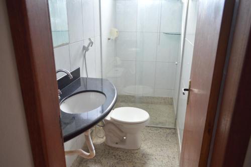 a bathroom with a sink and a toilet at Vivenda Casagrande in Marataizes