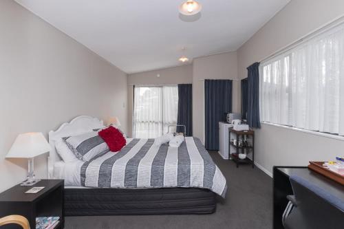a bedroom with a bed and a large window at Quiet Boutique Generous Breakfast in Palmerston North