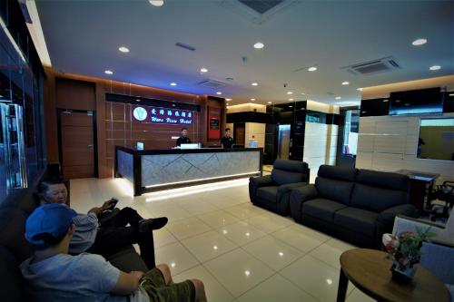 a group of people sitting in a living room at Wave View Hotel in Semporna