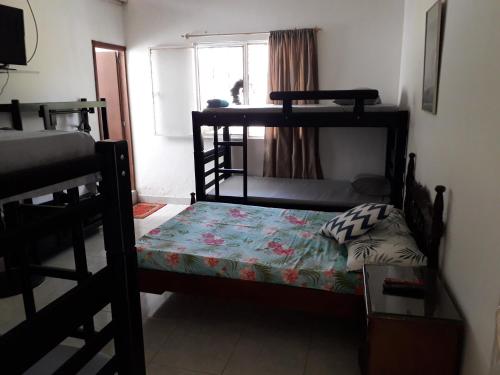 a bedroom with a bunk bed and a window at Finca la Miradita in Cumaral