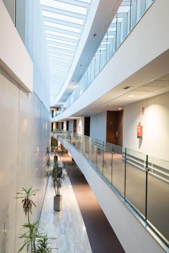 an empty hallway in a building with potted plants at ARVA Abad San Antonio in León