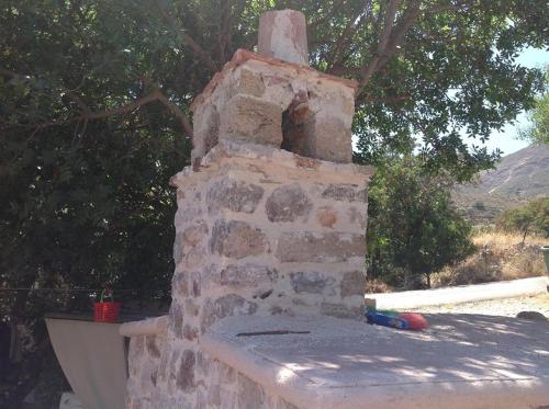 a brick oven sitting on top of a wall at Castellania Hotel Apartments in Livadia