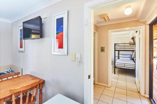 a hallway with a dining room and a bedroom at RAC Monkey Mia Dolphin Resort in Monkey Mia