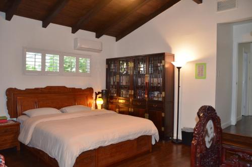 a bedroom with a bed and a dresser at LAX Teresa AIR B&B in Los Angeles