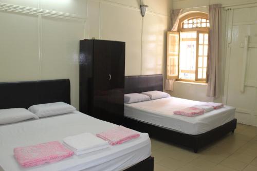 Voodi või voodid majutusasutuse Old Penang Hotel - Trang Road toas