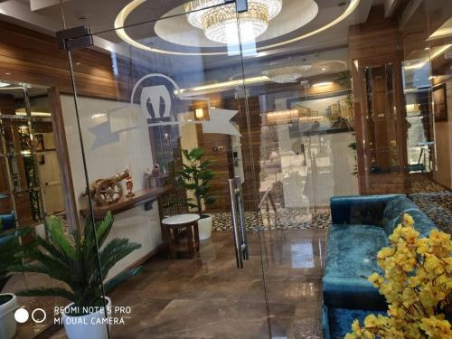 a lobby with a blue couch and a table at Hotel Makhan Residency in Amritsar