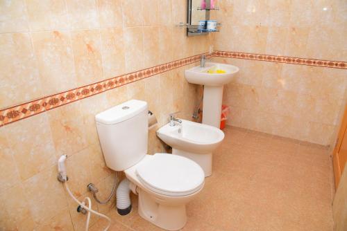 a bathroom with a toilet and a sink at White Villa Airport Transit Hotel in Katunayake