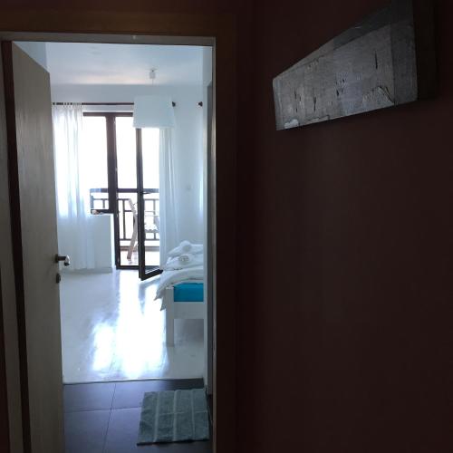 an open door to a room with a bedroom at Deep Blue Guest House in Sozopol