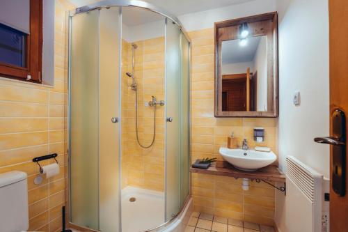a bathroom with a shower and a sink at Liptovské Chaty in Liptovský Mikuláš