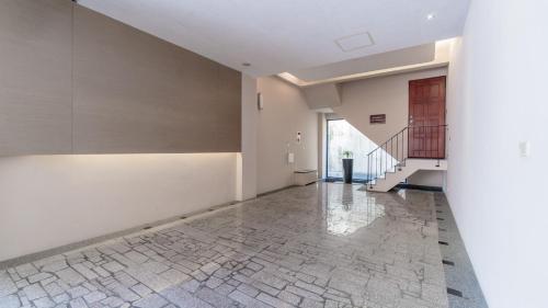 an empty room with a staircase and a tile floor at G.SHOCK Motel in Pingtung City