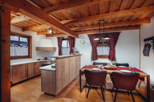 a kitchen with a wooden table and chairs at Liptovské Chaty in Liptovský Mikuláš