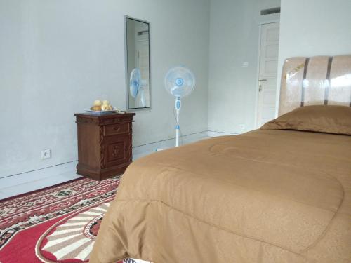 Postel nebo postele na pokoji v ubytování Mandi Angin "Syariah" Homestay