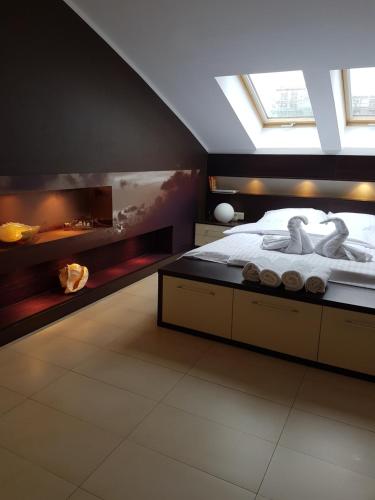 a bedroom with a bed with two swans on it at Apartament Baltic Marea in Międzyzdroje