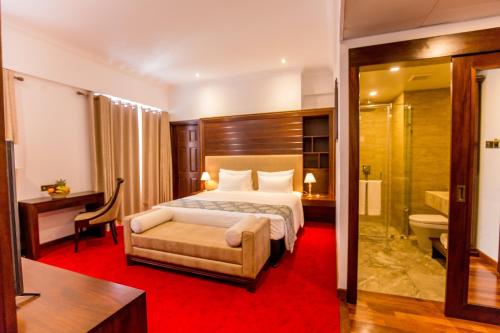 Trillium Boutique City Hotel tesisinde bir odada yatak veya yataklar