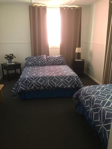 a hotel room with two beds and a window at Riverfront Cottage in Booderee National Park at Christians Minde in Jervis Bay Village
