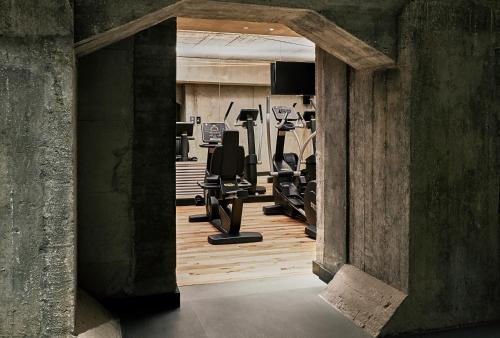 a gym with treadmills and exercise equipment in a building at Hotel Warszawa in Warsaw