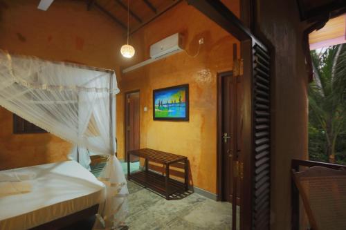 a room with a bedroom with a bed and a window at Limecabanas-srilanka in Galle