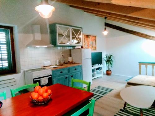 a kitchen with a table with a bowl of fruit on it at Apartments Jago in Piran