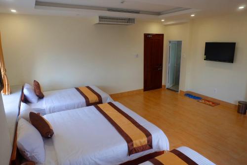 Giường trong phòng chung tại Green Hotel Quy Nhơn