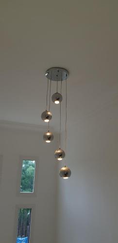 a chandelier hanging from the ceiling in a room at Heather's Retreat in Brufut
