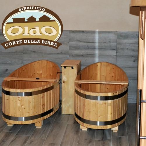 two wooden barrels in a room with a sign at CORTE DELLA BIRRA - OLDO in Cadelbosco di Sopra