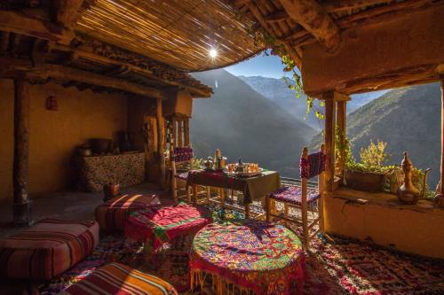 a room with chairs and a table with a view at Berber Family Lodge in Imlil