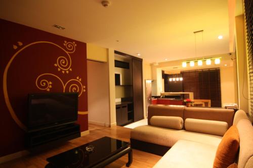 a living room with a couch and a television at Pattaya tower room 7 in Pattaya