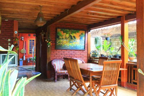 a dining room with a wooden table and chairs at Oemah Kajoe Lembang in Lembang