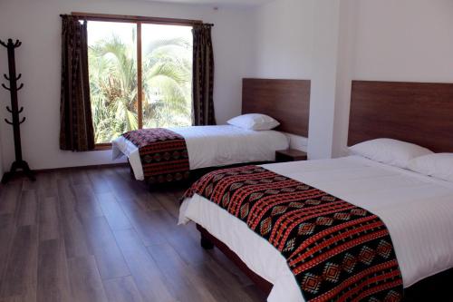 Postel nebo postele na pokoji v ubytování Hotel El Geranio