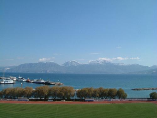 a view of a large body of water with mountains at Stunning Seaview Town Apartment in Agios Nikolaos