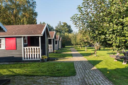 a house with a brick path in front of a yard at Dromen bij de boer in Oene