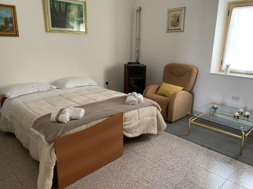 sypialnia z dużym łóżkiem i krzesłem w obiekcie Fra il MARE e la SILA w mieście Cerenzia