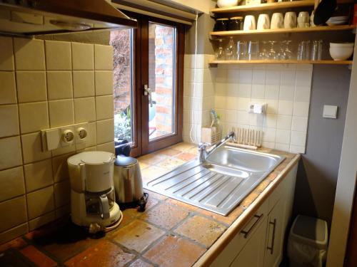 a kitchen with a sink and a window at Le Fournil Gîte Rural in Trois-Ponts