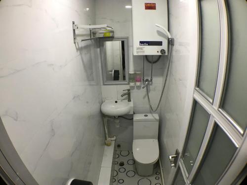 a bathroom with a toilet and a sink and a shower at Soso Hostel in Hong Kong