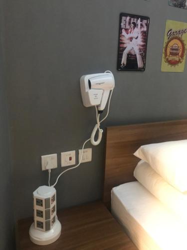 a hotel room with a bed and a camera on the wall at Soso Hostel in Hong Kong