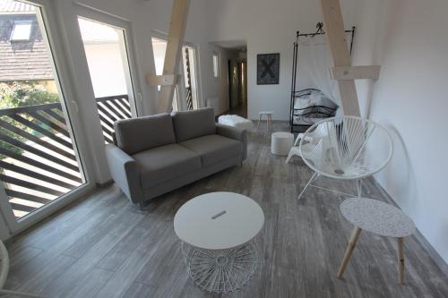 a living room with a couch and a table at Subtil insolite in Colmar