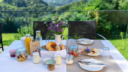 a table with a basket of bread and a bowl of food at WURZENBERG Hotel Lodges Südsteiermark in Gamlitz