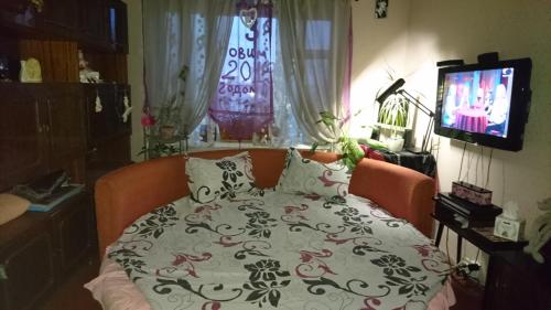 a bedroom with a bed with a blanket on it at Apartment on Raisy Okipnoi 5 in Kyiv