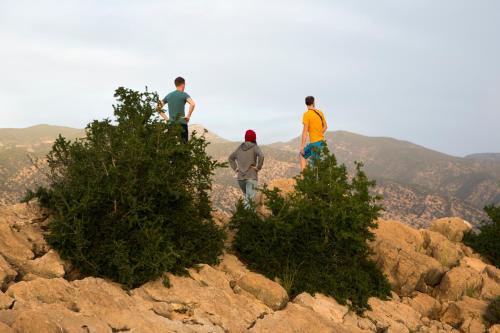 three people standing on the top of a mountain at GOLVEN Surf in Taghazout