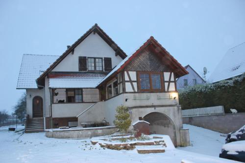 a house in the snow with a garage at CHEZ SANDRINE in Surbourg