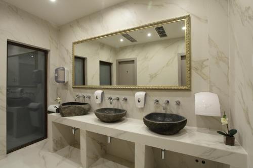 two sinks in a bathroom with a large mirror at Solun Hotel & SPA in Skopje